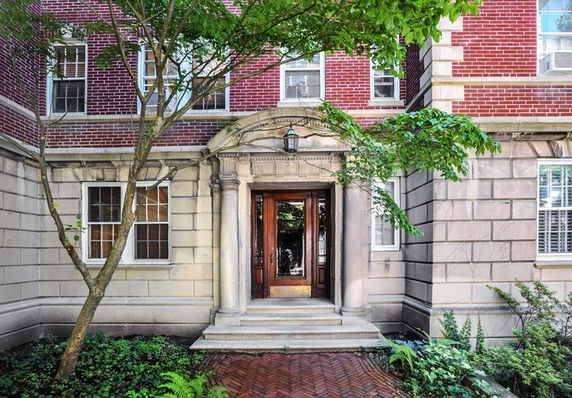 Front view of a brick building with an ornate entrance.