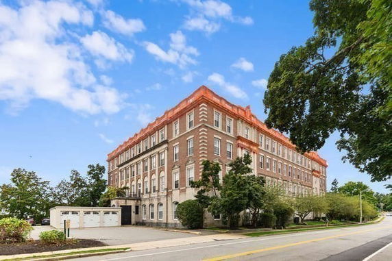 Front view of a large multi-story brick building.