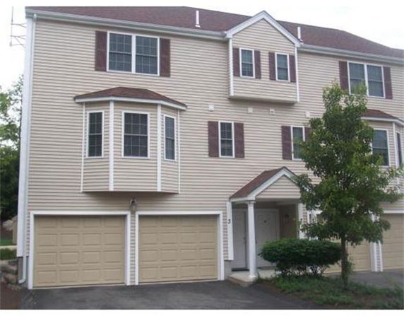 Front view of a multi-story house with double garage.