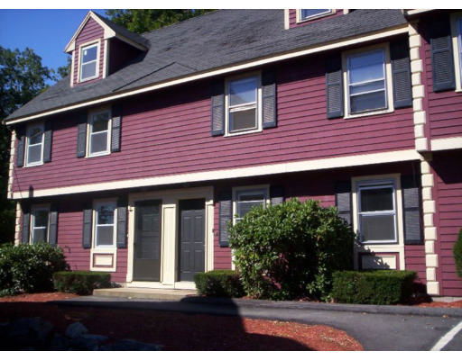 Front view of a two-story house with a gabled roof and red siding.