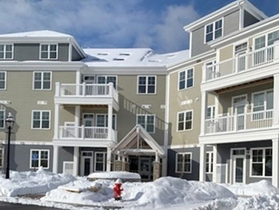 Front view of a multi-story residential building with balconies.