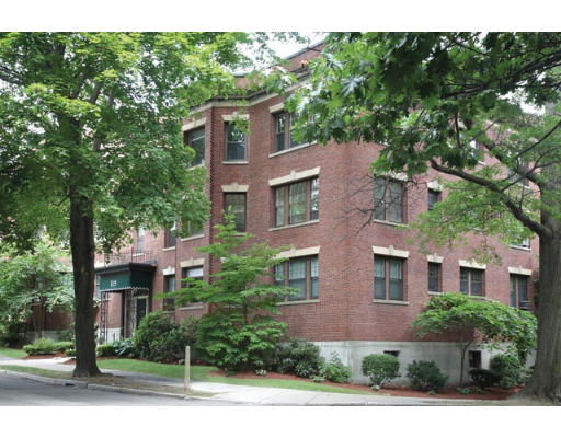 Front view of a brick residential building with multiple windows.