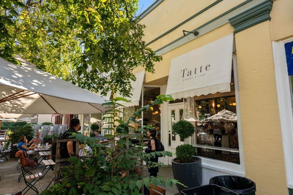 Front view of a cafe with outdoor seating.