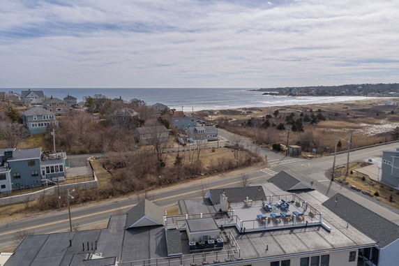 Panoramic view of houses and coastline with ocean in the distance.