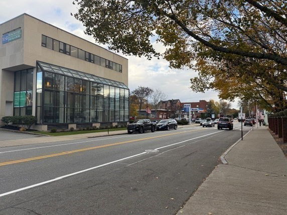 Front view of a multi-story commercial building with large windows.