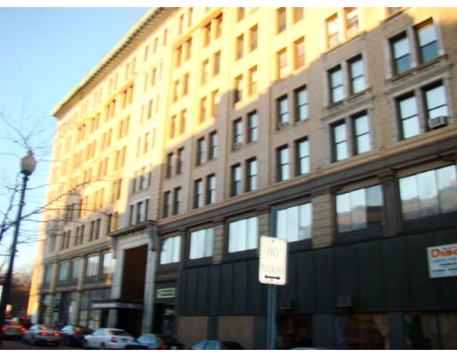 Front view of a multi-story building with numerous windows and a central entrance.