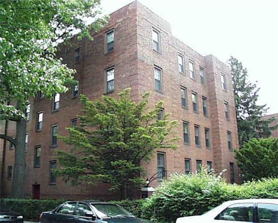 Front view of a multi-story brick apartment building.