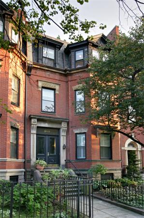 Front view of a multi-story brick townhouse.