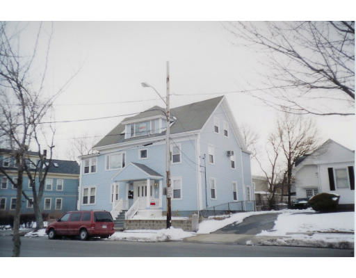 Front view of a two-story house with an attic and a driveway.