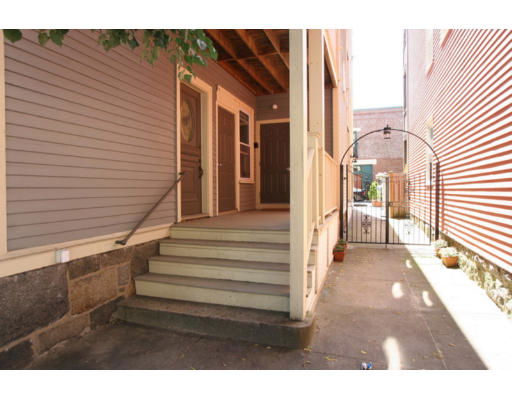 Front view of a house with wooden steps leading to the entrance.
