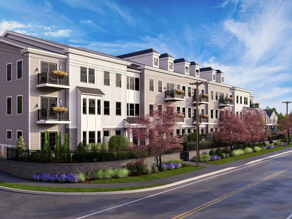 Front view of a multi-story apartment building with balconies.