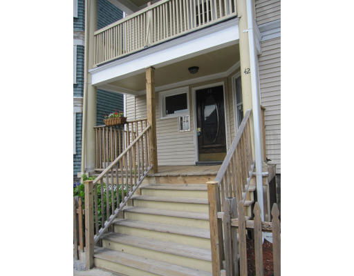 Front view of a house entrance with steps leading to a porch and door.