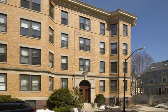 Front view of a multi-story brick apartment building.