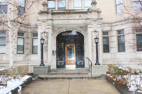 Front view of a multi-story building with an ornate entrance.