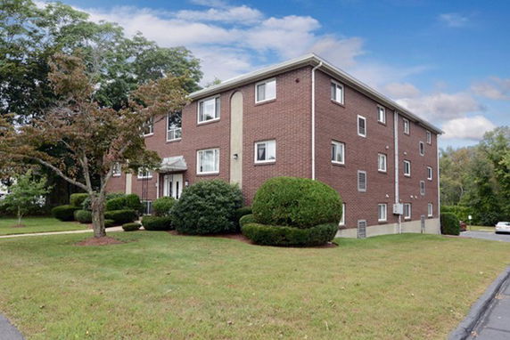 Front view of a multi-story brick apartment building.