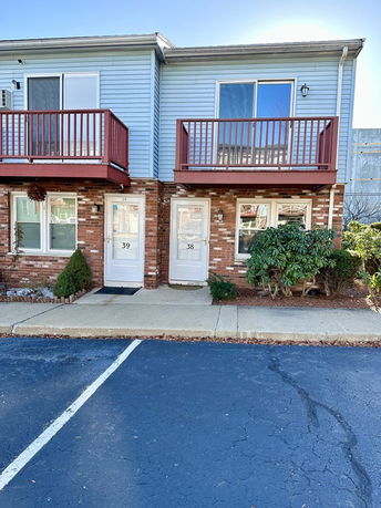 Front view of a two-story townhouse with balconies.