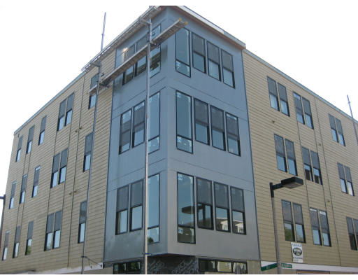 Front view of a multi-story building with large windows and modern design.