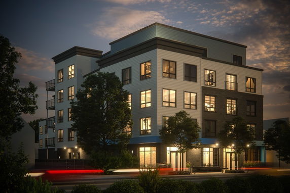 Front view of a multi-story residential building with illuminated windows.