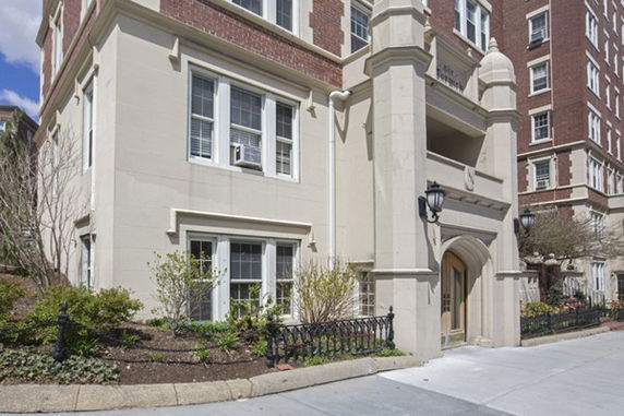 Front view of a multi-story building with decorative facade and entrance.