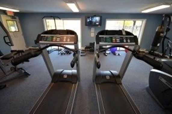Interior view of a gym area with two treadmills and exercise equipment.