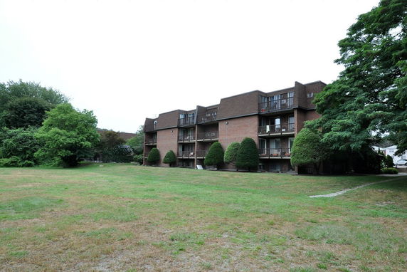 Front view of a multi-story brick apartment building.