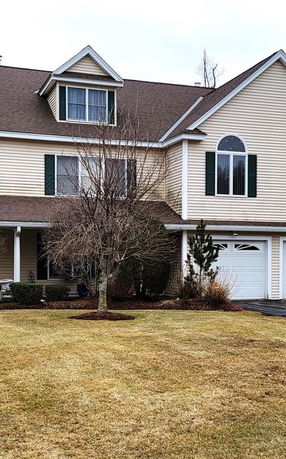 Front view of a two-story house with a garage.