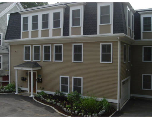 Front view of a multi-story house with multiple windows and a small portico entrance.