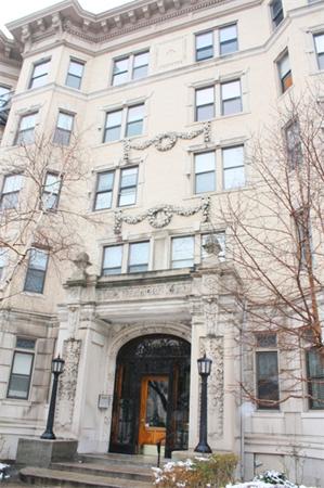 Front view of a multi-story building with ornate details.
