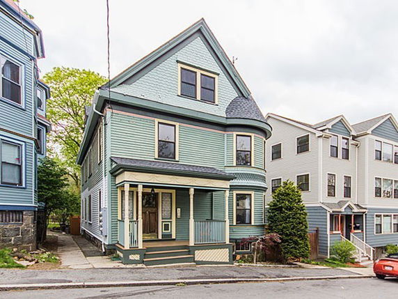 Front view of a two-story house with a blue exterior and a small porch.