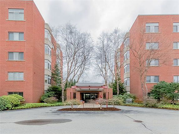 Front view of a multi-story brick building with a central entrance.