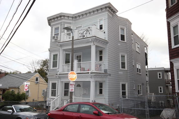 Front view of a three-story residential building with balconies