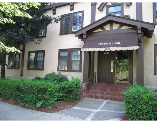 Front view of a building with an awning over the entrance labeled 'Tudor Manor'.