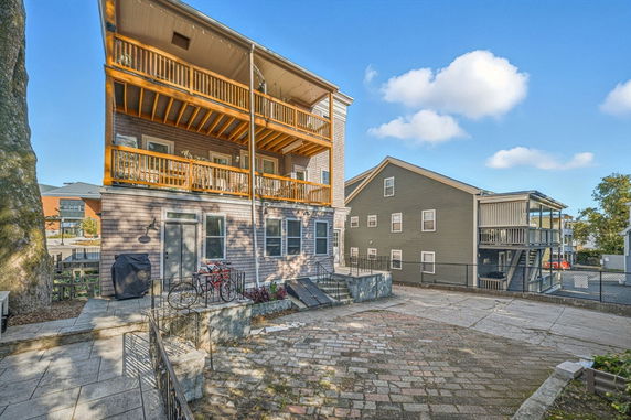 Front view of a multi-story house with balconies.
