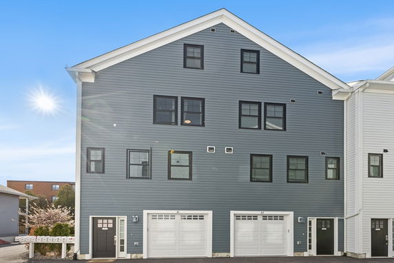 Front view of a multi-story building with attached garages.