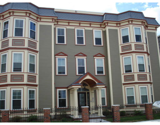 Front view of a three-story building with bay windows and a central entrance.