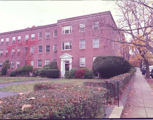 Front view of a three-story brick apartment building.