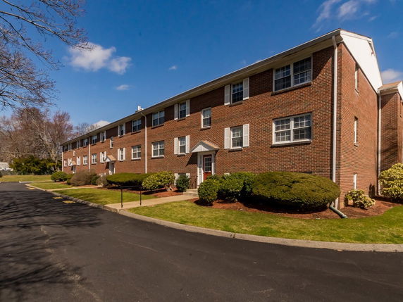 Front view of a two-story brick apartment building.