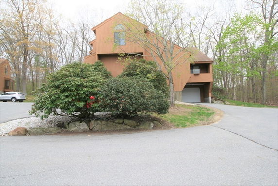 Front view of a multi-story house with a unique geometric design.