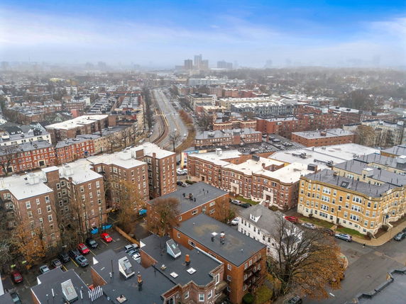 Aerial view of a cityscape with multiple residential buildings and roads in an urban area.