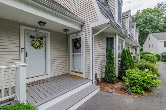 Front view of a townhouse with two entrances, A11 and A12, featuring a shared porch.