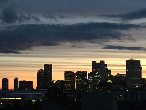 Panoramic view of a city skyline at sunset.