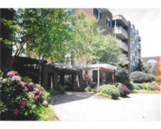 Front view of a multi-story residential building with balconies.