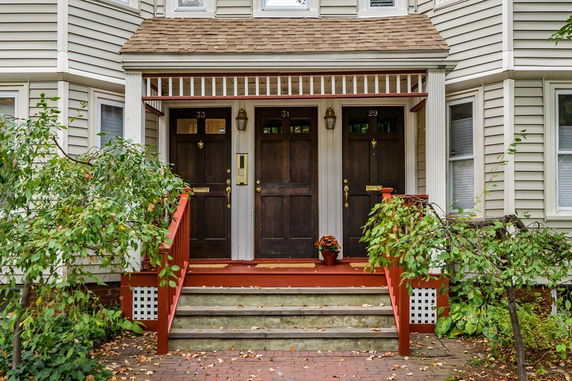Front view of a multi-unit house with separate entrances.