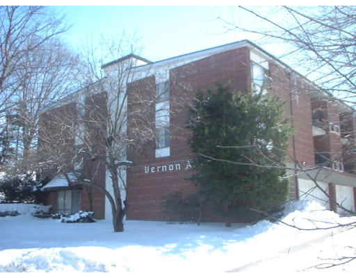 Front view of a multi-story brick building with a flat roof.