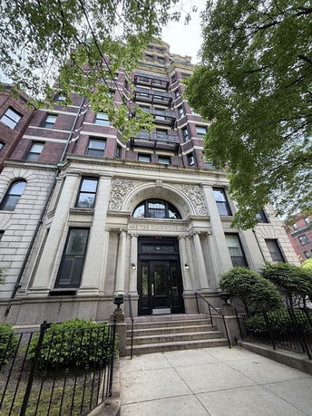 Front view of a multi-story building with decorative architectural details.