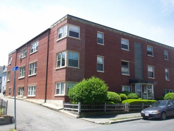 Front and side view of a three-story brick building