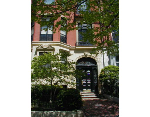 Front view of a multi-story building with ornate architectural details and a decorative entrance.