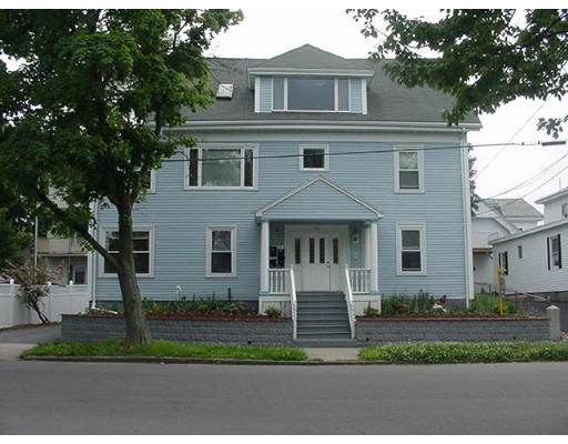 Front view of a two-story house with multiple windows and a central entrance.