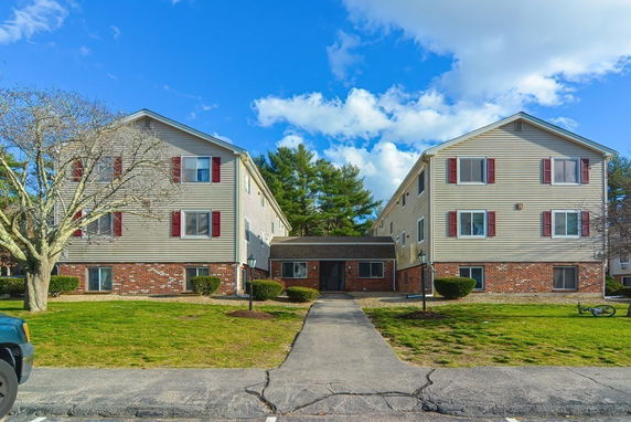 Front view of a two-story apartment building with brick and siding exterior.