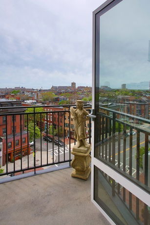 Balcony view overlooking cityscape from a high vantage point.